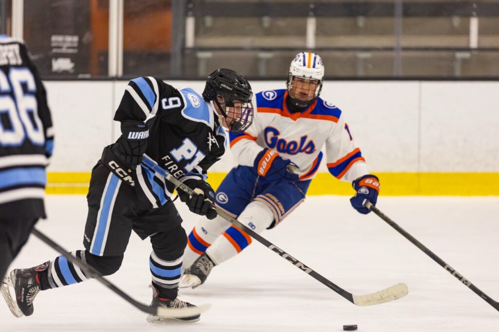 an ice hockey player skates past an opponent