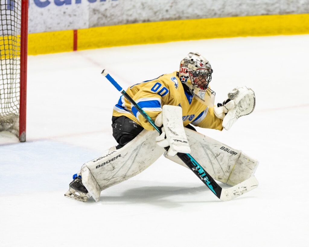 A hockey goalie prepares to make a save