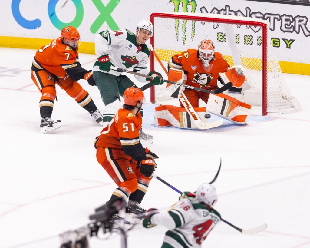 Anaheim Ducks goaltender Lukas Dostal makes a save through traffic off a shot by Jared Spurgeon of the Minnesota Wild during an NHL game at Honda Center.
