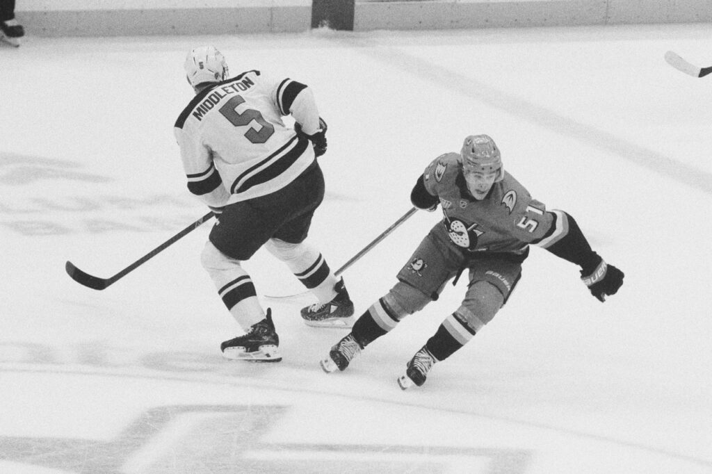 Olen Zelwegger of the Anaheim Ducks pokes at a puck being passed by an opponent